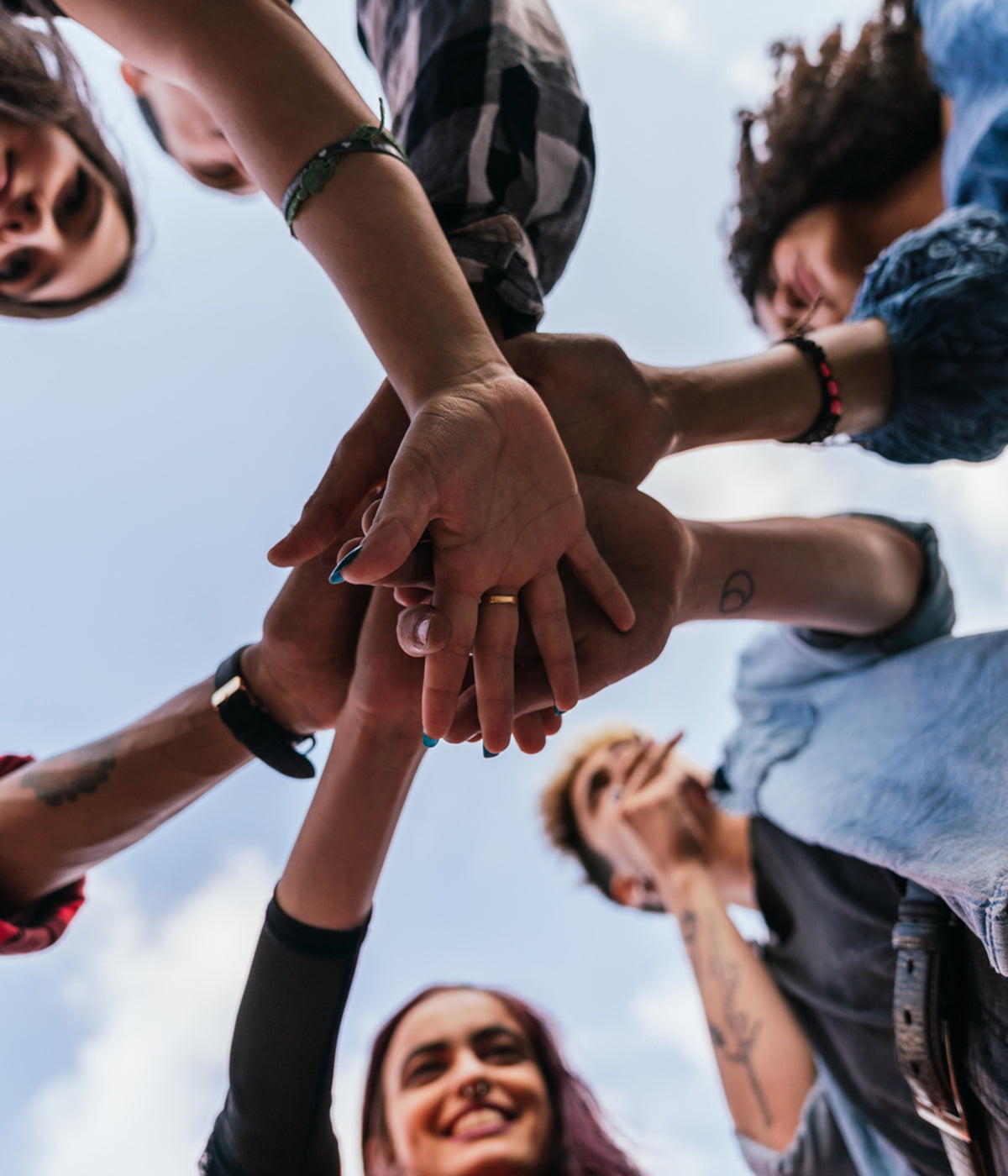 A group of people putting their hands together
